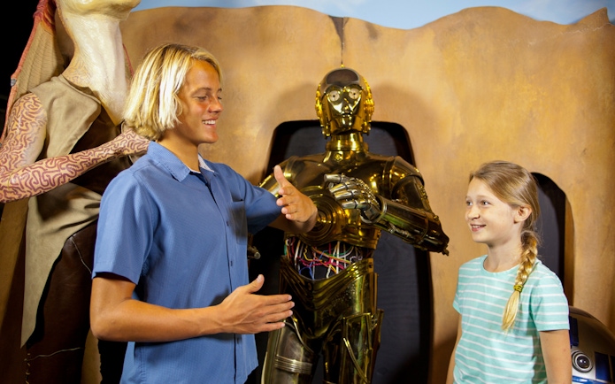Visitors interacting with wax figures of C-3PO and Jar Jar Binks at St. Augustine Potter's Wax Museum.
