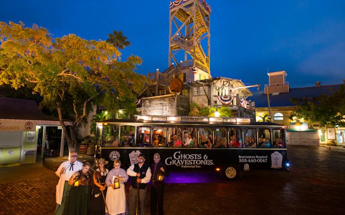 St. Augustine Ghosts & Gravestones tour trolley with guides in period costumes at night.