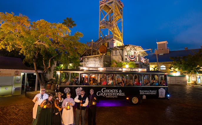 St. Augustine Ghosts & Gravestones tour trolley with guides in period costumes at night.