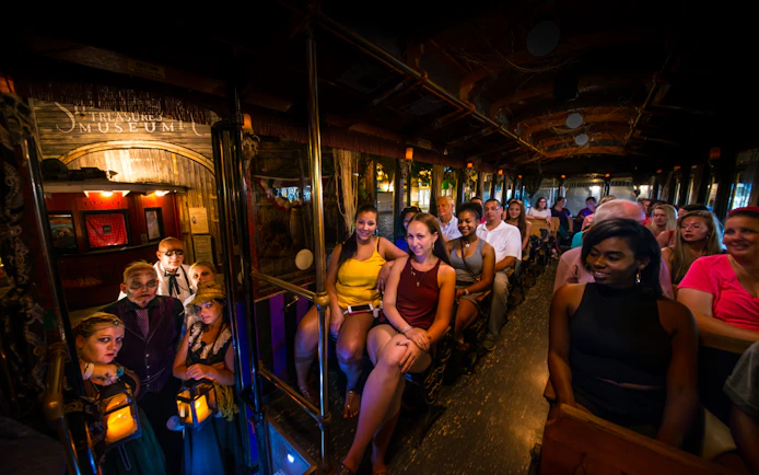 Tourists on St. Augustine Ghosts & Gravestones trolley with costumed guides.