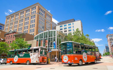 Old Town Trolley buses in Washington DC near historic buildings.