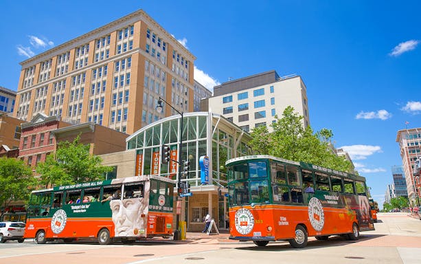 Old Town Trolley buses in Washington DC near historic buildings.