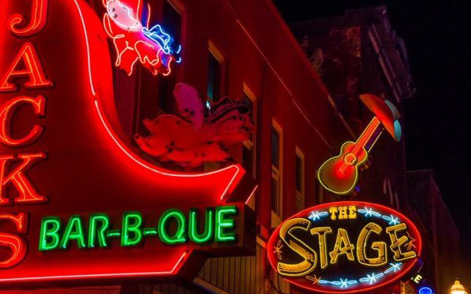 Neon signs of Jack's Bar-B-Que and The Stage on Broadway, Nashville at night.