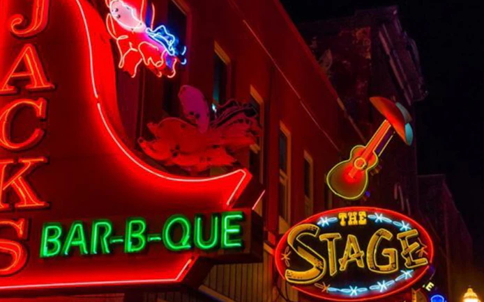 Neon signs of Jack's Bar-B-Que and The Stage on Broadway, Nashville at night.