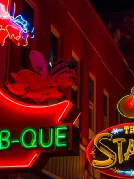 Neon signs of Jack's Bar-B-Que and The Stage on Broadway, Nashville at night.