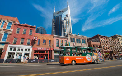 Nashville Old Town Trolley passing historic buildings with AT&T Building in background.