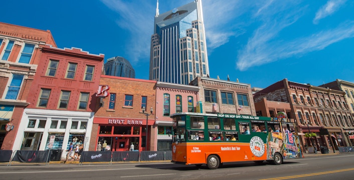 Nashville Old Town Trolley passing historic buildings with AT&T Building in background.