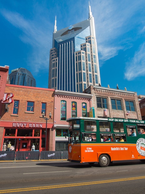 Nashville Old Town Trolley passing historic buildings with AT&T Building in background.