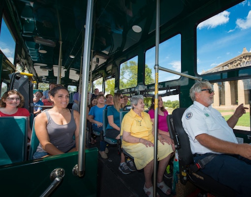 Passengers on Nashville hop-on hop-off trolley tour passing the Parthenon replica.