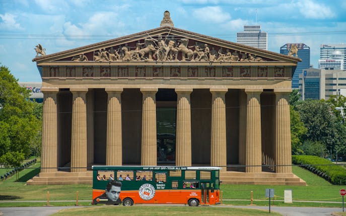 Nashville Parthenon with Old Town Trolley Tour bus in front.