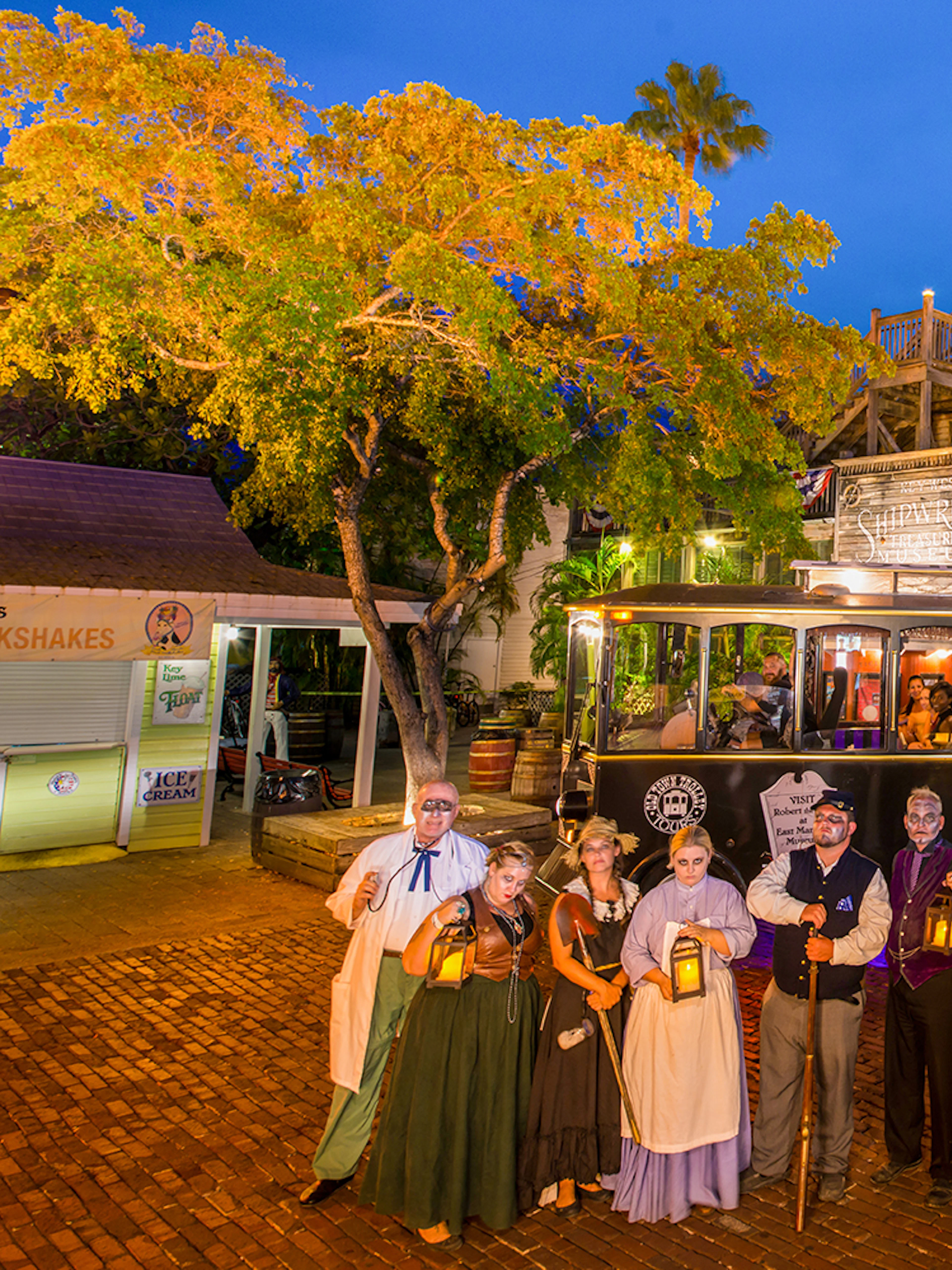 Ghost tour trolley with costumed guides in front of historic building, Boston Ghosts & Gravestones.