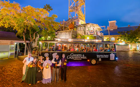 Ghost tour trolley with costumed guides in front of historic building, Boston Ghosts & Gravestones.