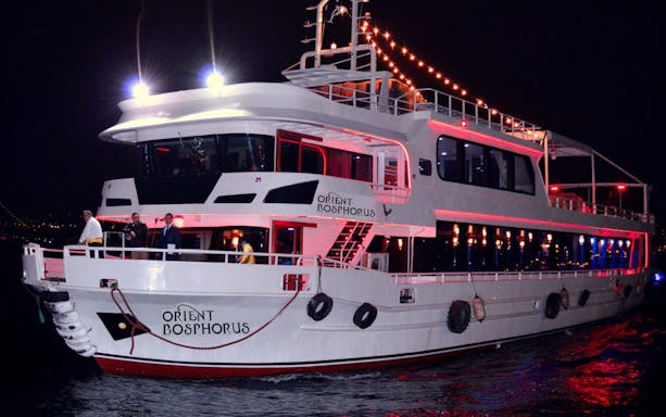 Cruise ship illuminated at night during Bali Sunset Cruise.