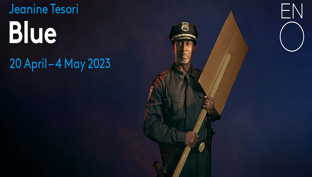 Police officer holding a cardboard sign for the opera "Blue" by Jeanine Tesori, ENO, April-May 2023.