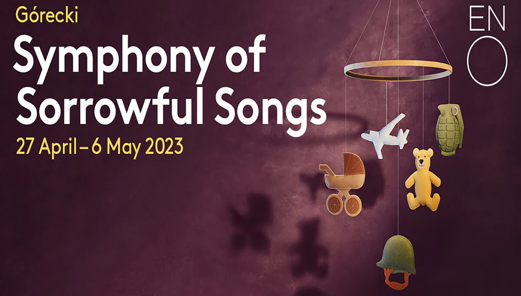 Górecki's Symphony of Sorrowful Songs poster with mobile of toys and military items.