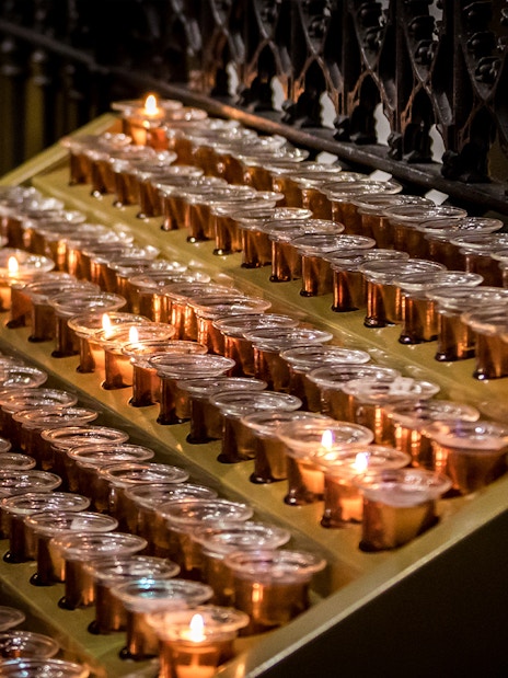 Lighting candles inside Milan Duomo during Skip-the-Line tour.