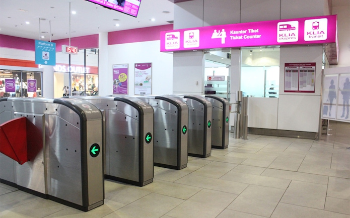 KLIA Ekspress ticket counter and turnstiles at Kuala Lumpur station.
