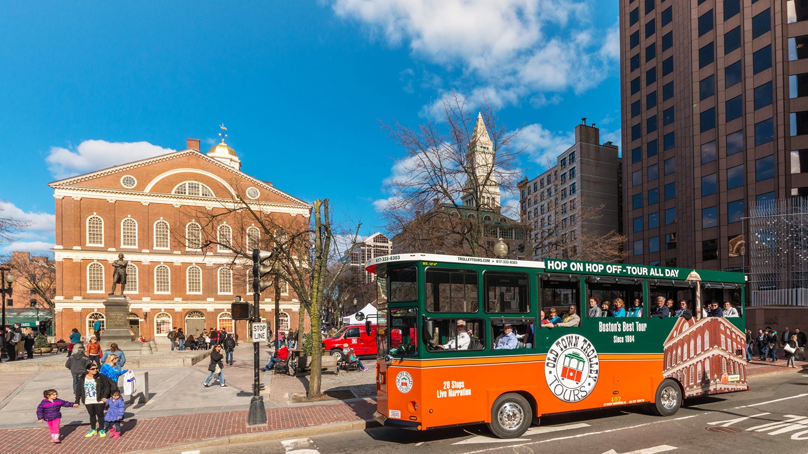 Boston Old Town Trolley passing historic brick buildings in downtown Boston.
