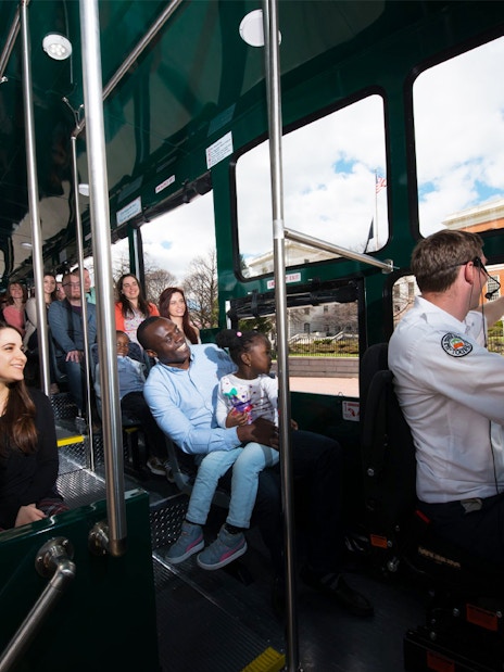 Passengers inside Old Town Trolley Bus in Boston, viewing the Massachusetts State House.