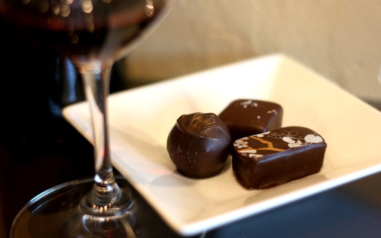 Chocolates on a plate with a glass of wine, Downtown New York tour.