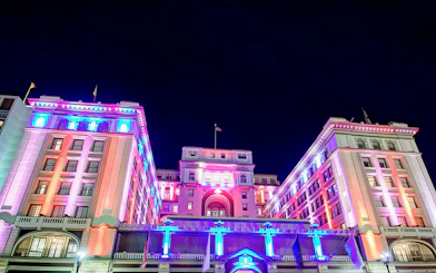 Historic San Diego building illuminated with colorful lights at night.