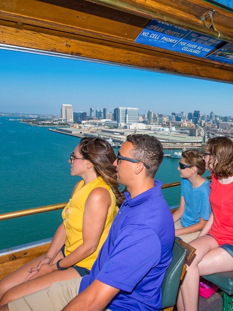 Tourists enjoying a scenic view of the San Diego skyline from an Old Town trolley.