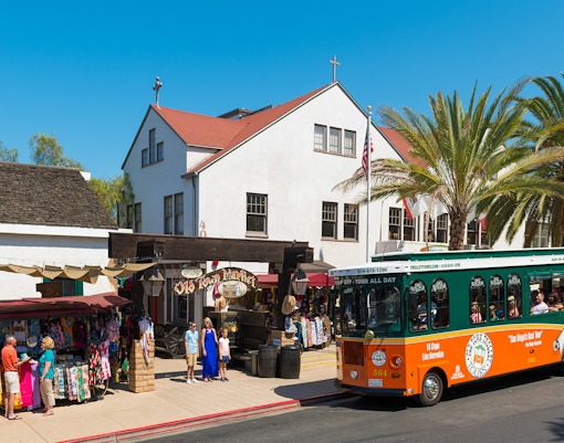 San Diego Old Town Trolley Tour passing historic buildings and palm trees.