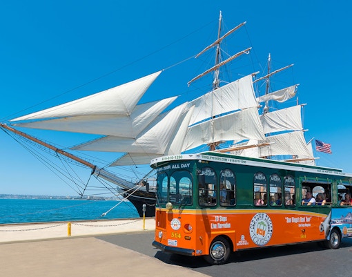 San Diego Old Town Trolley passing historic buildings on hop-on hop-off tour route.