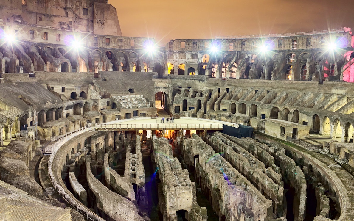 Colosseum interior at night during Underground & Arena Tour in Rome.