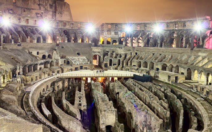 Colosseum interior at night during Underground & Arena Tour in Rome.