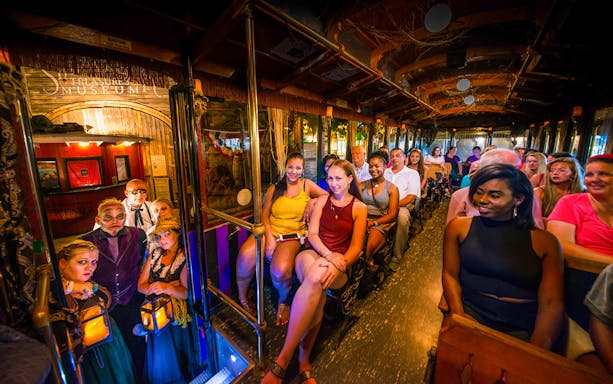 Tour group on Savannah's 'Ghosts & Gravestones' trolley with costumed guides.