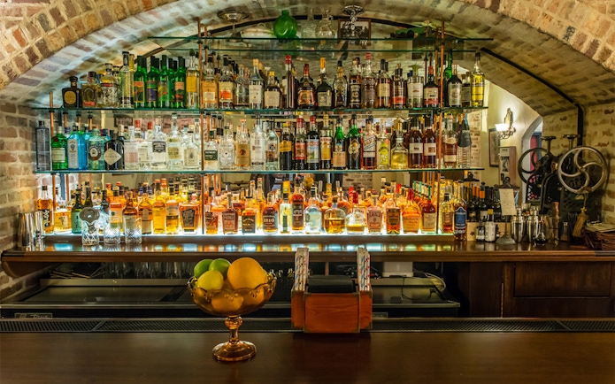 Bar display with vintage liquor bottles at American Prohibition Museum.