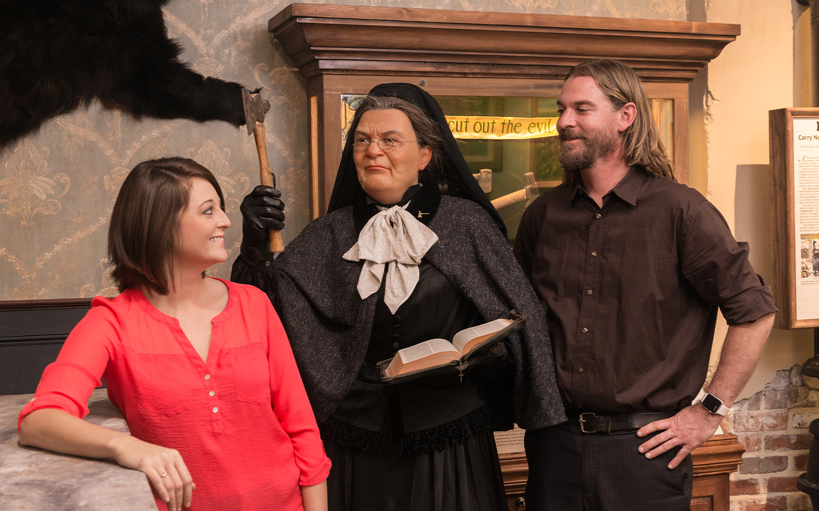Visitors interacting with a wax figure at the American Prohibition Museum.