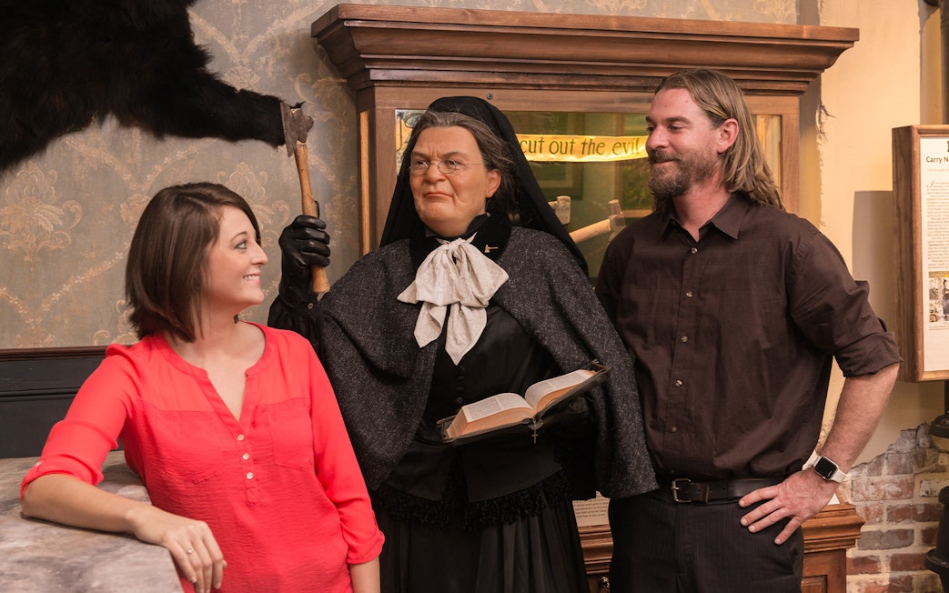 Visitors interacting with a wax figure at the American Prohibition Museum.