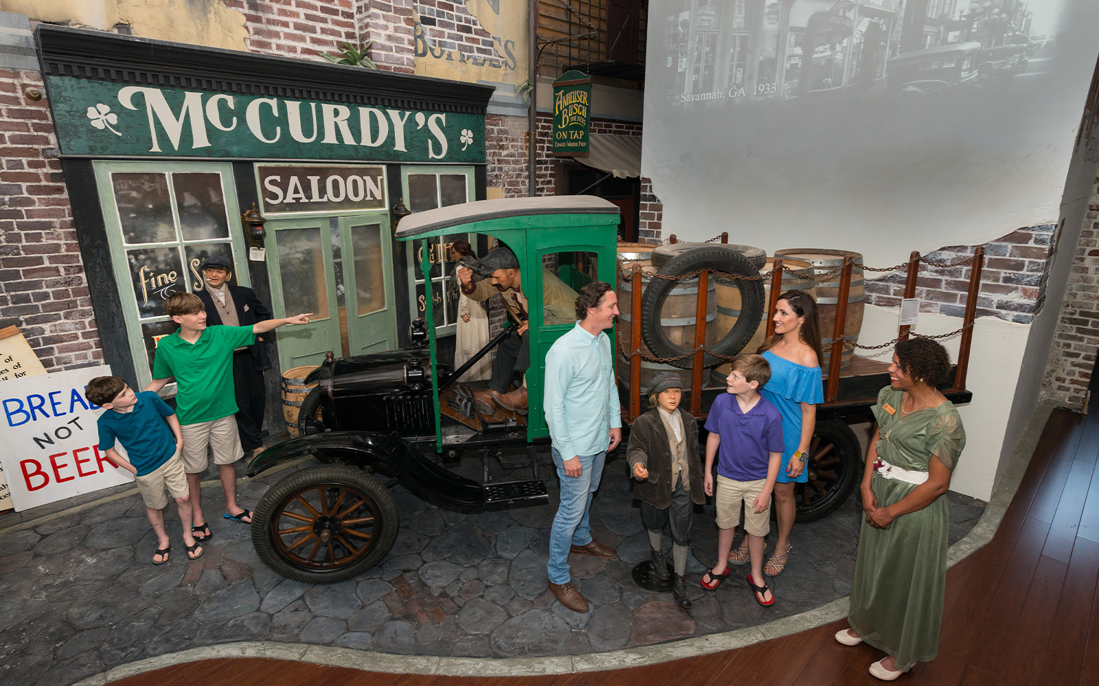Visitors explore a vintage truck exhibit at the American Prohibition Museum in Savannah.