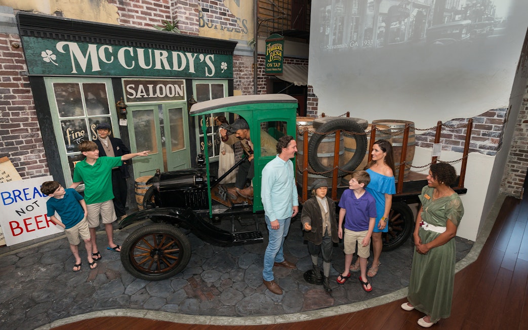 Visitors explore a vintage truck exhibit at the American Prohibition Museum in Savannah.