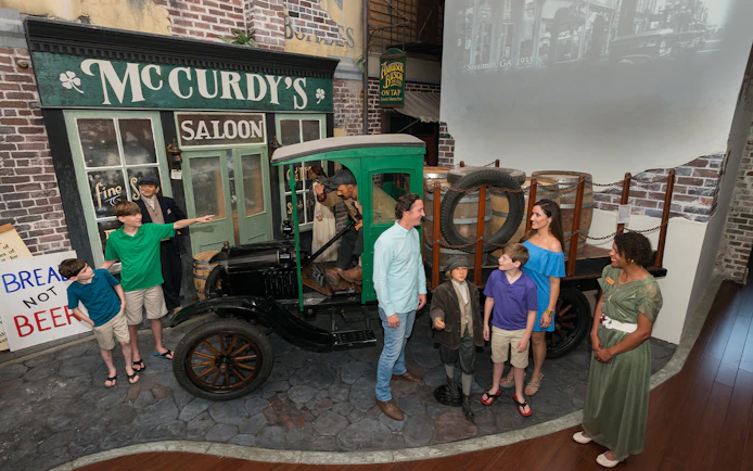 Visitors explore a vintage truck exhibit at the American Prohibition Museum in Savannah.