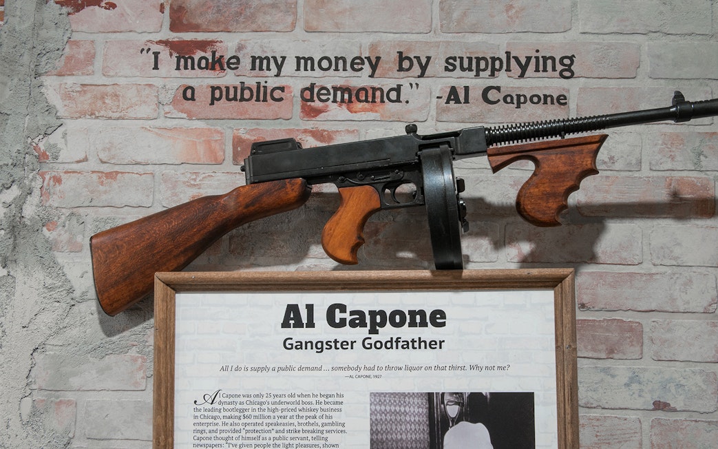 Al Capone exhibit with quote and Tommy gun at American Prohibition Museum.