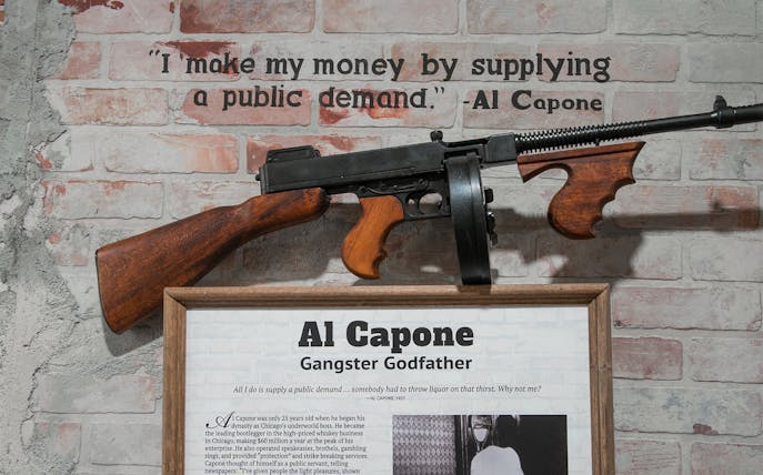 Al Capone exhibit with quote and Tommy gun at American Prohibition Museum.