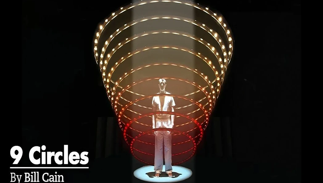 Man standing under illuminated spiral structure, related to "9 Circles" by Bill Cain.