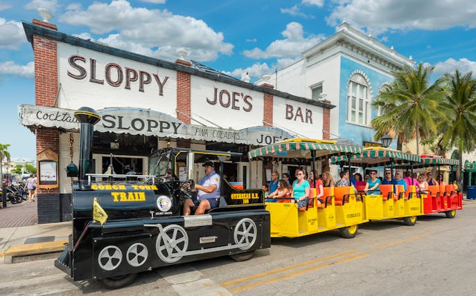 Guided Conch Tour Train passing Sloppy Joe's Bar in Key West.