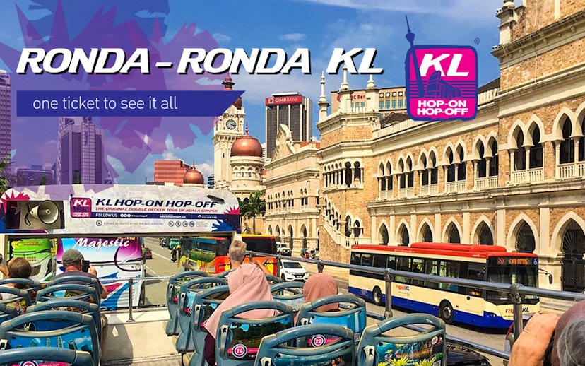 KL Hop-on Hop-off bus passing Sultan Abdul Samad Building in Kuala Lumpur.