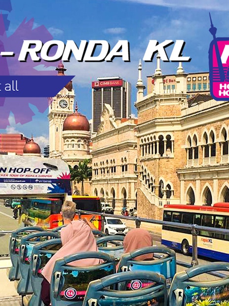 KL Hop-on Hop-off bus passing Sultan Abdul Samad Building in Kuala Lumpur.