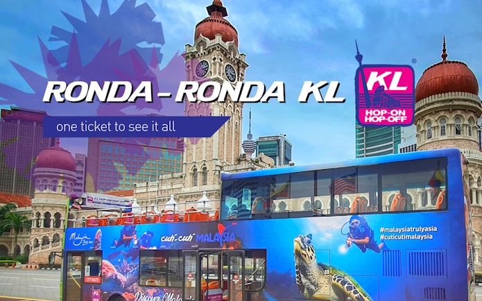 KL Hop-on Hop-off bus in front of Sultan Abdul Samad Building, Kuala Lumpur.