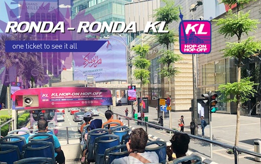Open-top bus on Kuala Lumpur street for Hop On Hop Off tour near Sunway Lagoon.