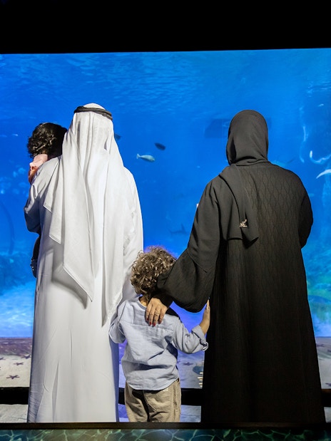 Family viewing marine life at National Aquarium Abu Dhabi.