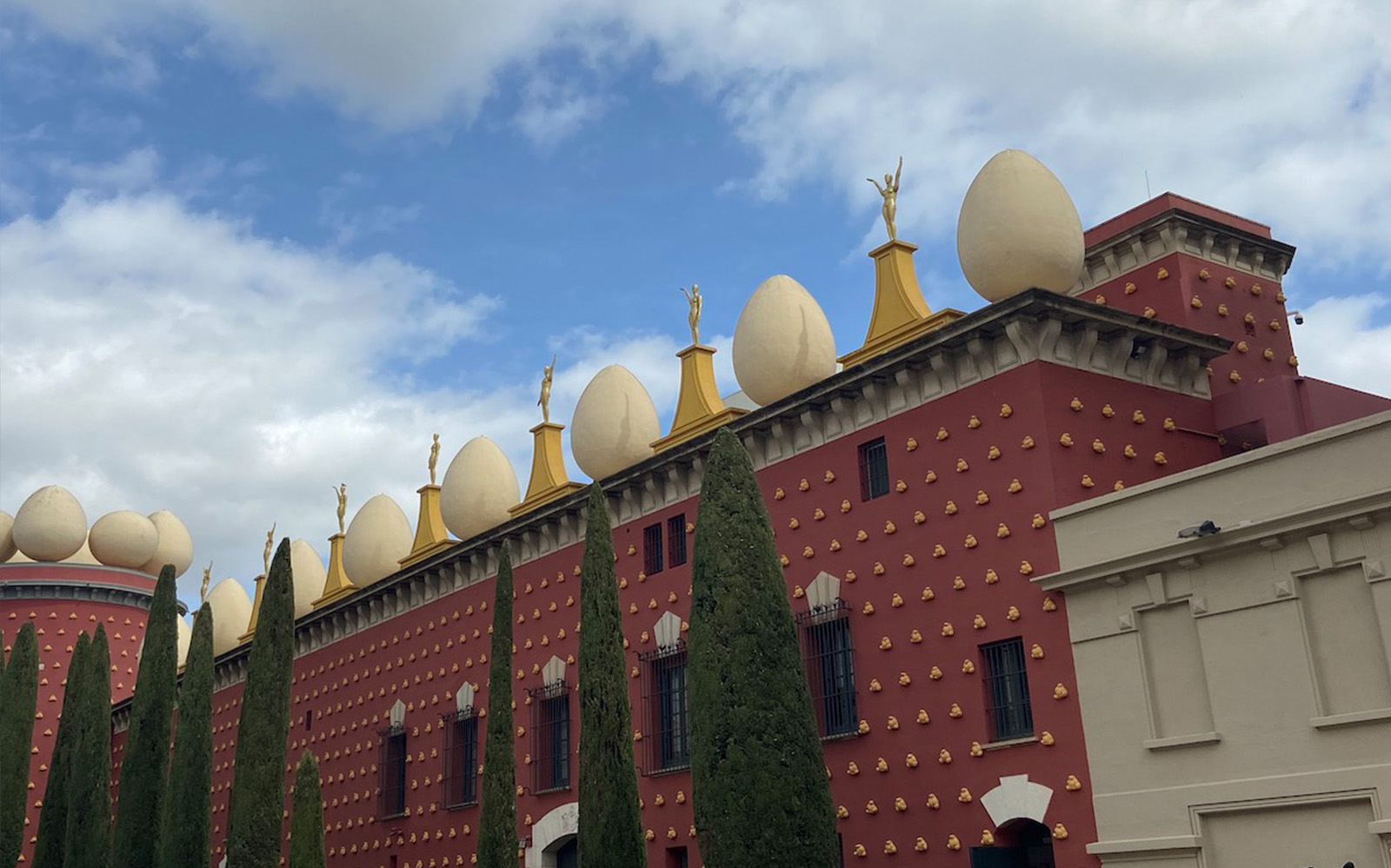 Dalí Museum exterior with egg sculptures and statues in Figueres, Spain.