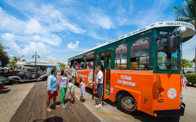 Key West Old Town Trolley with tourists boarding for a narrated tour.