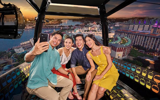 Group enjoying a scenic view from a cable car in Singapore.