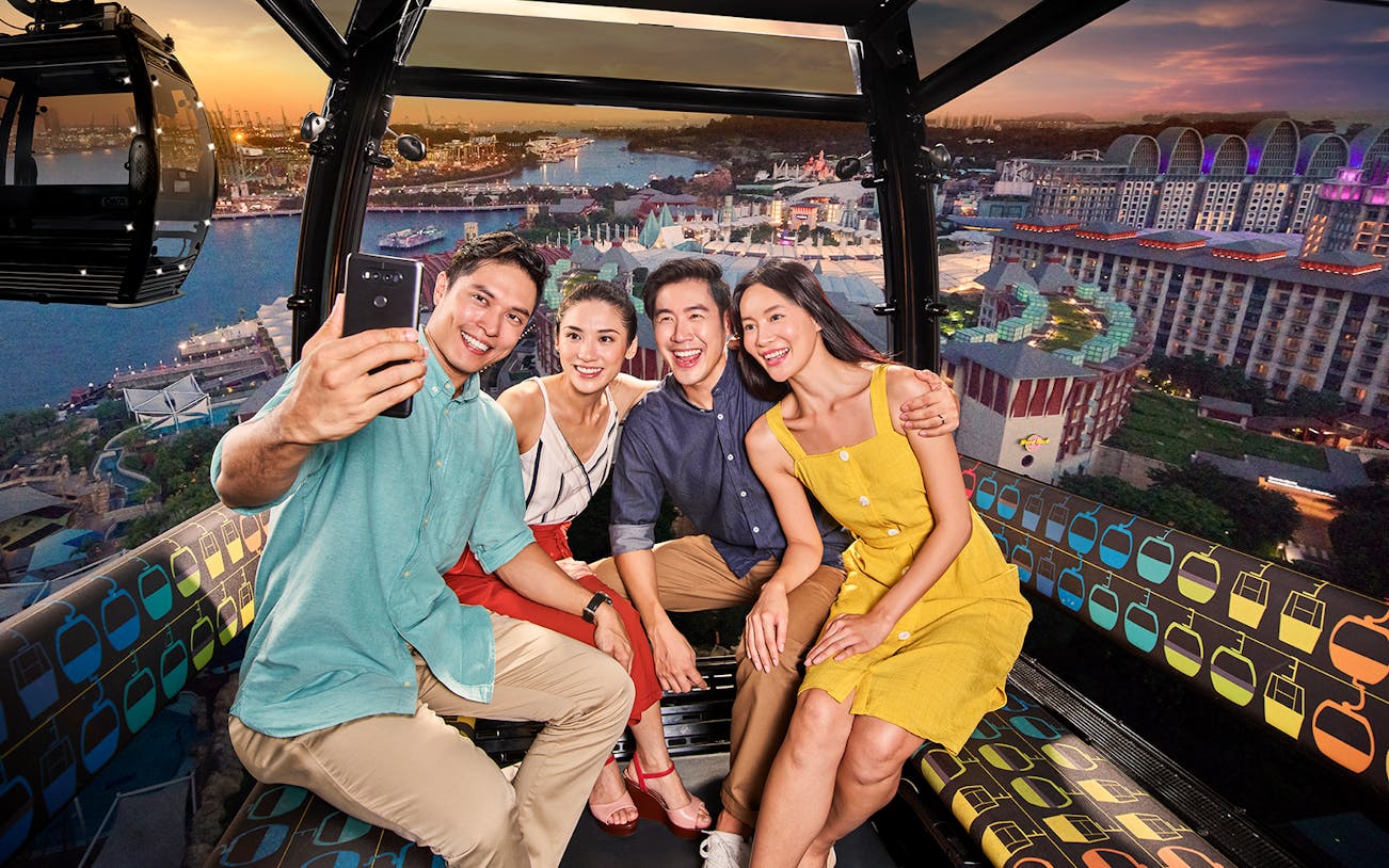 Group enjoying a cable car ride with cityscape view, AJ Hackett Giant Swing experience.